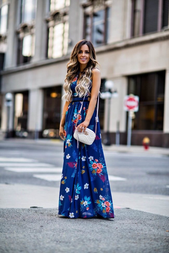 fashion blogger mia mia mine wearing a blue floral dress from express for spring
