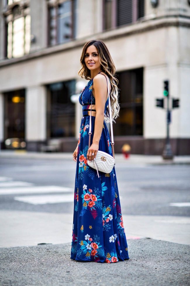 fashion blogger mia mia mine wearing a blue floral dress from express and a white gucci bag