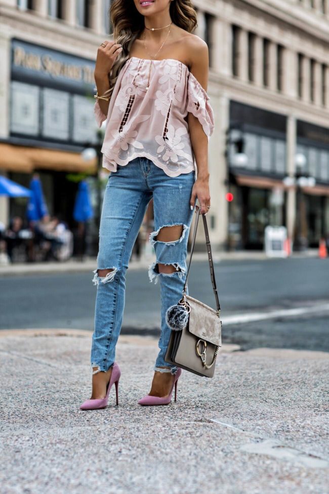 fashion blogger mia mia mine wearing  a lovers + friends pink lace top and ripped jeans
