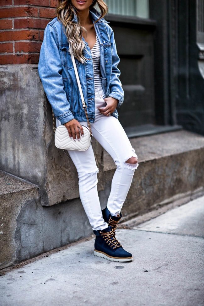 fashion blogger mia mia mine wearing timberland boots and a denim jacket