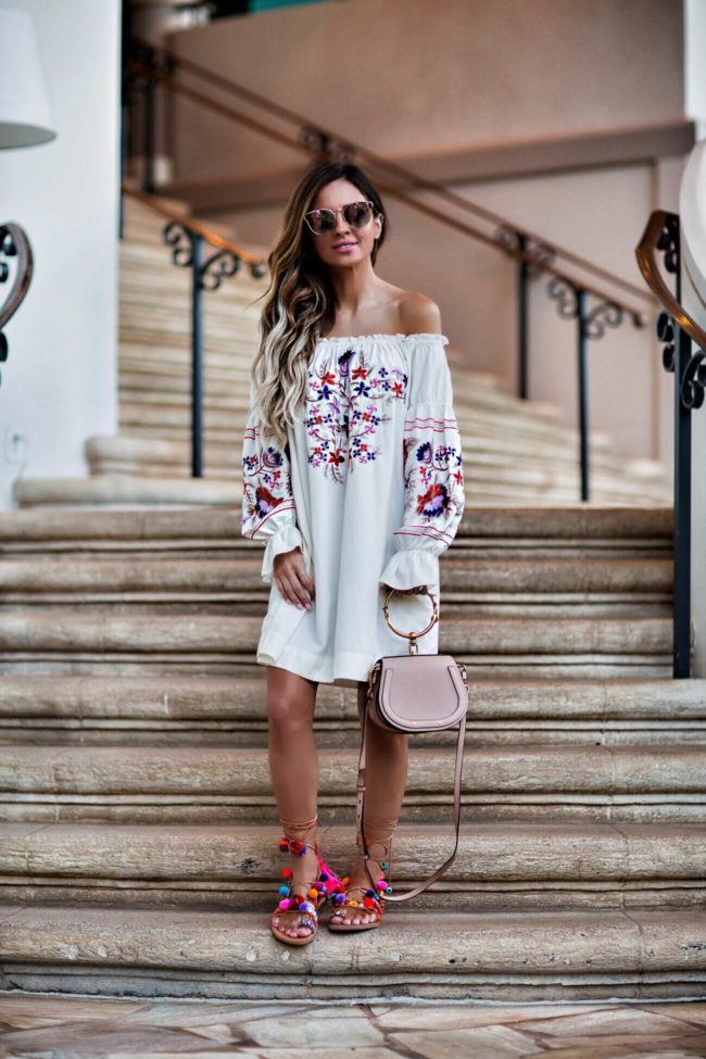 fashion blogger mia mia mine wearing an embroidered dress by free people