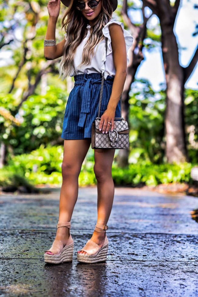 fashion blogger mia mia mine wearing joa shorts and a gucci dionysus bag