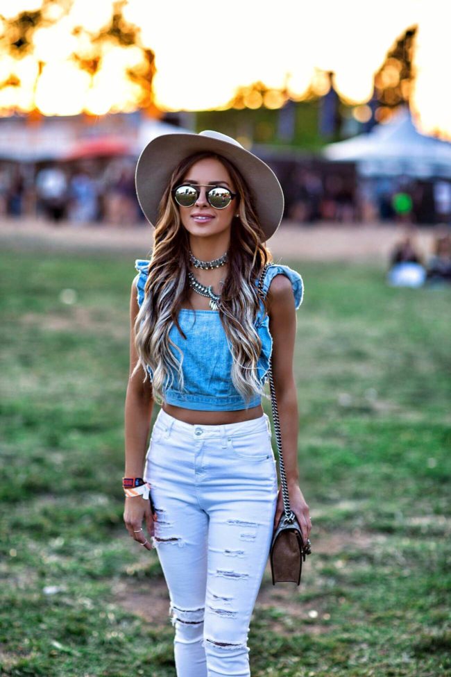 fashion blogger mia mia mine wearing a denim crop top from urban outfitters at bottlerock in napa