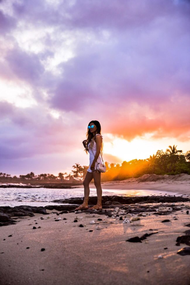 fashion blogger mia mia mine wearing a white romper in kona hawaii at the four seasons resort hualalai