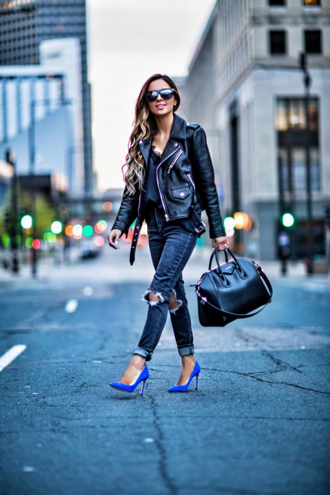 fashion blogger mia mia mine wearing a black leather jacket and blue jimmy choo heels from nordstrom