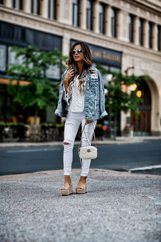 fashion blogger mia mia mine wearing a white eyelet top and a topshop studded denim jacket from nordstrom