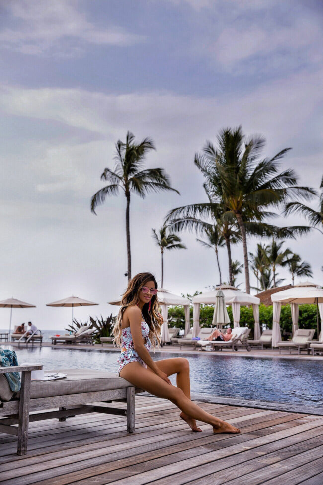 fashion blogger mia mia mine wearing a minkpink floral swimsuit at the four seasons resort hualalai in hawaii