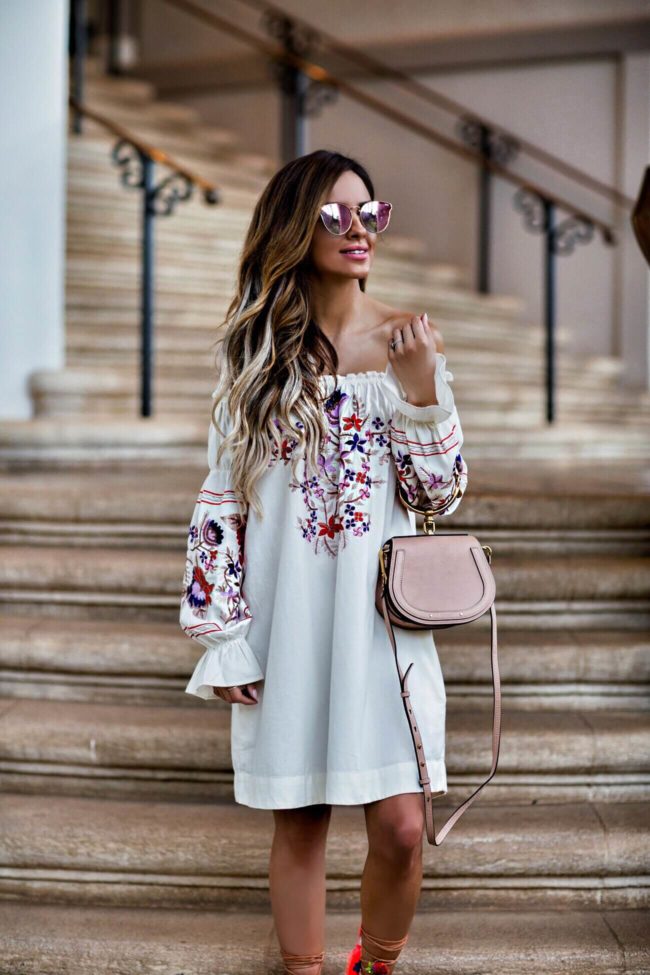 fashion blogger mia mia mine wearing an embroidered free people dress and quay pink sunglasses 