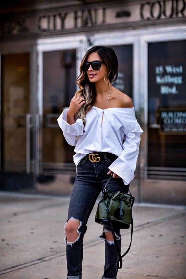 fashion blogger mia mia mine wearing a white button down and a gucci belt with a hunting world nyc bag