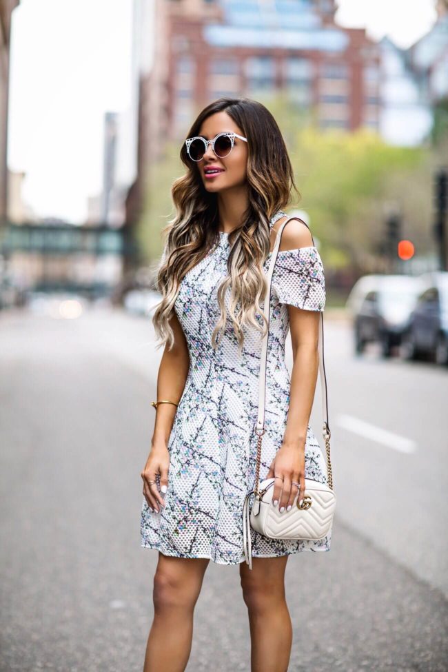 fashion blogger mia mia mine wearing a floral mini dress from revolve and a gucci marmont white bag