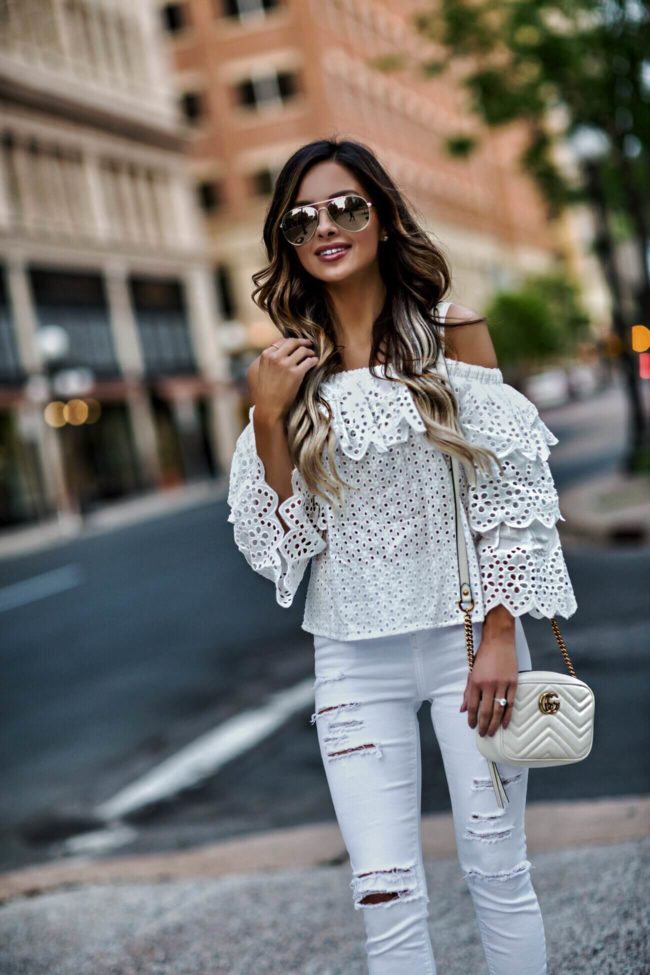 fashion blogger mia mia mine wearing a white eyelet top and white jeans from topshop