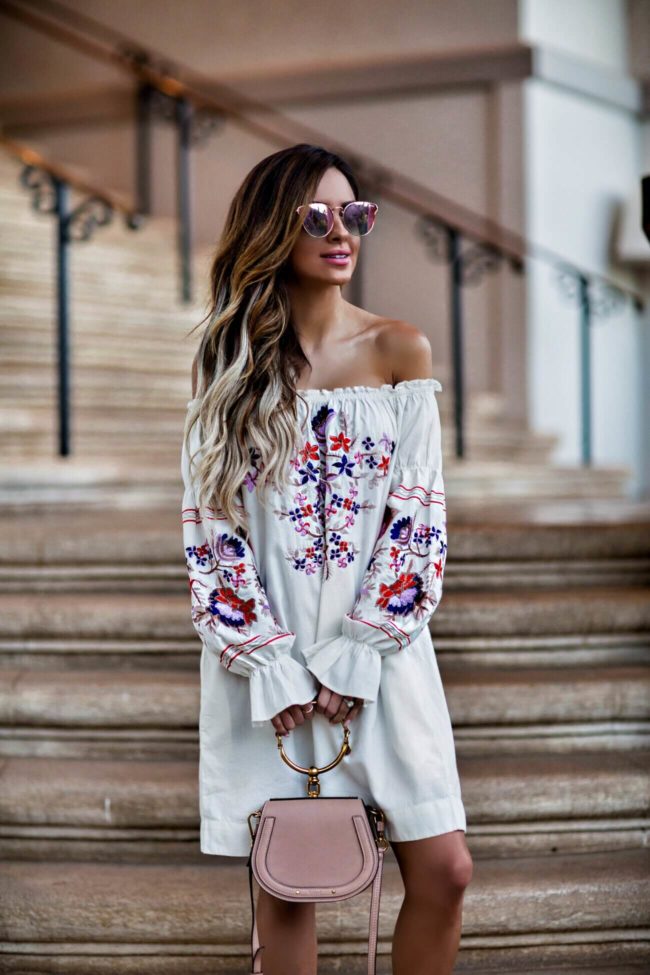 fashion blogger mia mia mine wearing an embroidered dress by free people and a chloe nile bag in maui hawaii