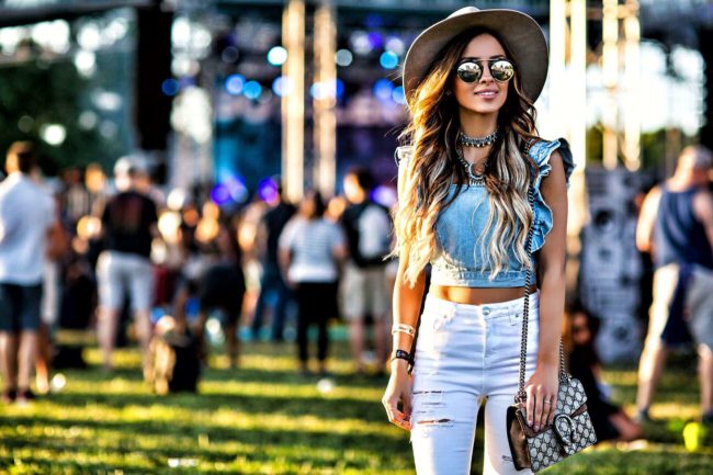fashion blogger mia mia mine wearing a denim crop top from urban outfitters and a gucci dionysus bag at bottlerock napa ca