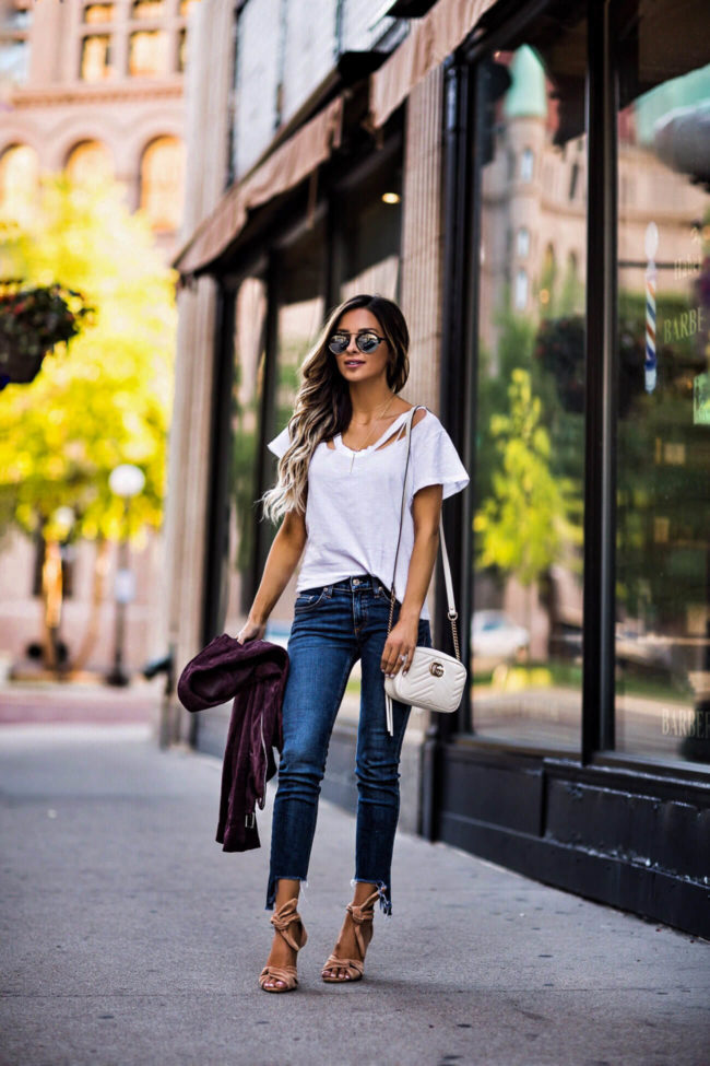 fashion blogger mia mia mine wearing a gucci white bag and illesteva sunglasses