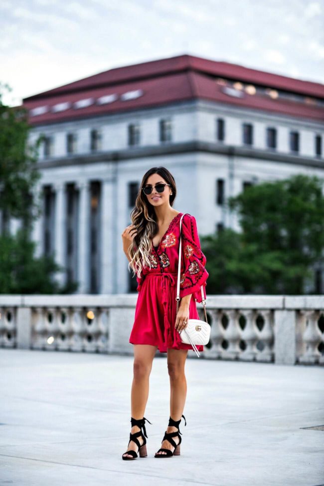 fashion blogger mia mia mine wearing an embroidered free people dress and ray-ban clubmaster sunglasses
