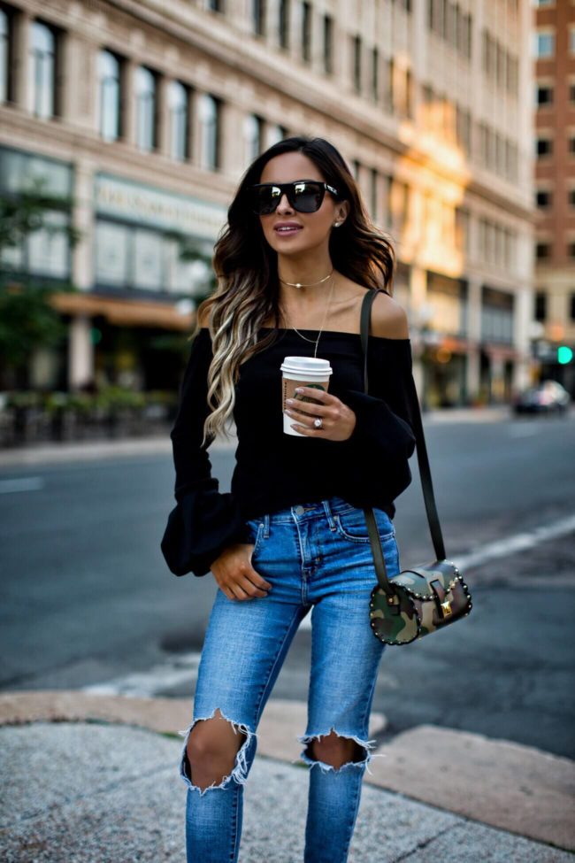 fashion blogger mia mia mine wearing a camo furla bag and levi's denim
