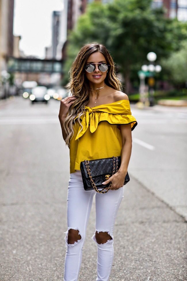 fashion blogger mia mia mine wearing a gold choker necklace from revolve and a mustard top for summer