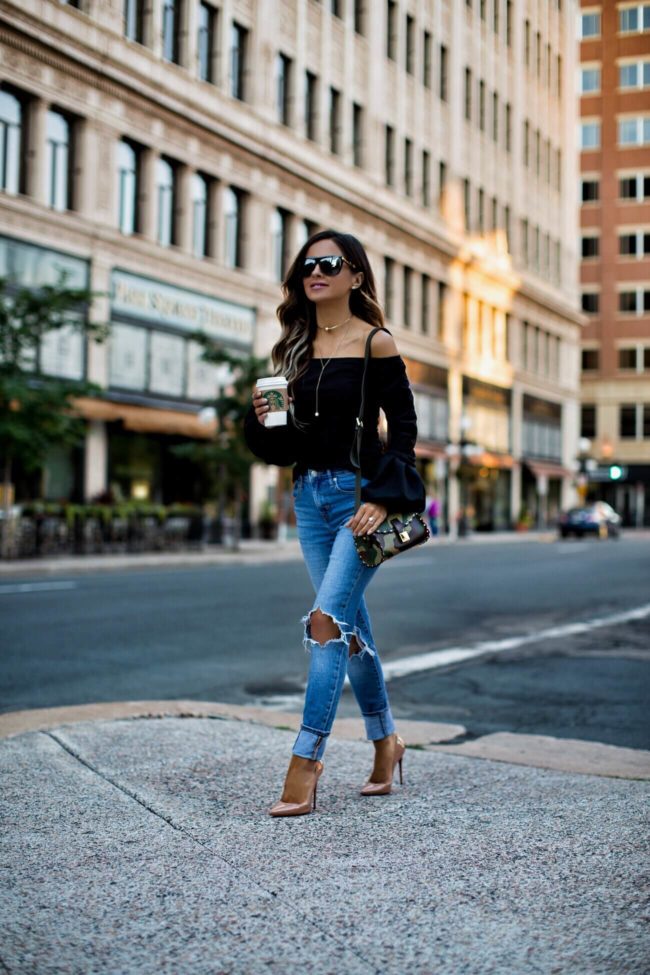 fashion blogger mia mia mine wearing a black asos bell sleeve top and levi's denim 