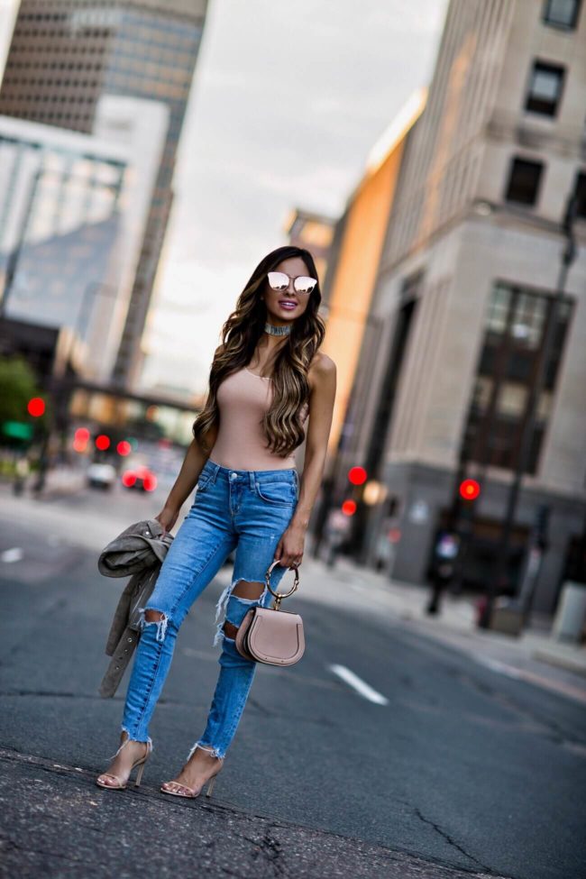 fashion blogger mia mia mine wearing ripped lovers + friends jeans from revolve and a blush bodysuit 