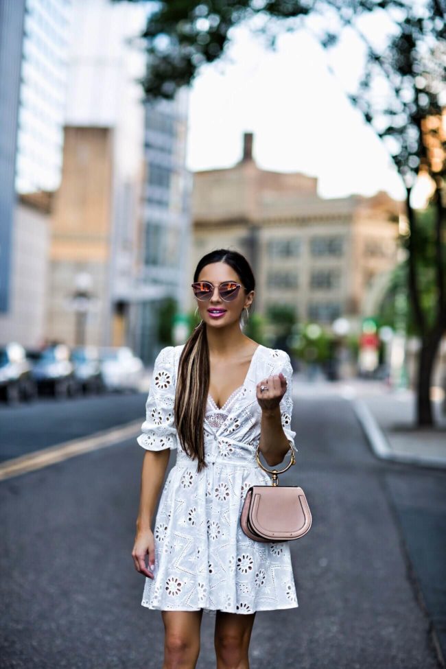 fashion blogger mia mia mine wearing a white eyelet dress from revolve by lovers + friends