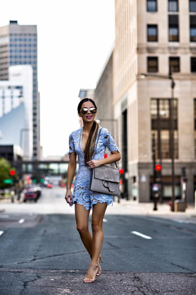 fashion blogger mia mia mine wearing a blue lace romper from nordstrom and a pony tail