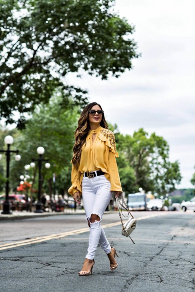 fashion blogger mia mia mine wearing a yellow free people top and steve madden heels from macy's