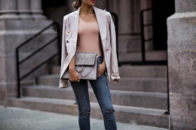 fashion blogger mia mia mine wearing a blush bodysuit from revolve and a chloe faye bag