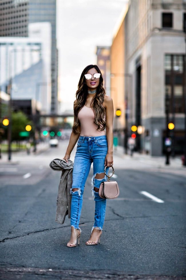 fashion blogger mia mia mine wearing a pink bodysuit from revolve and lovers + friends ripped jeans