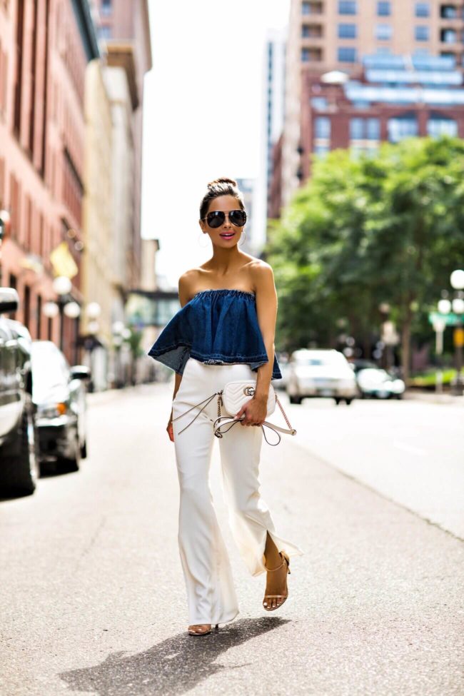 fashion blogger mia mia mine wearing a denim strapless top by j.o.a. from nordstrom and white pants from revolve