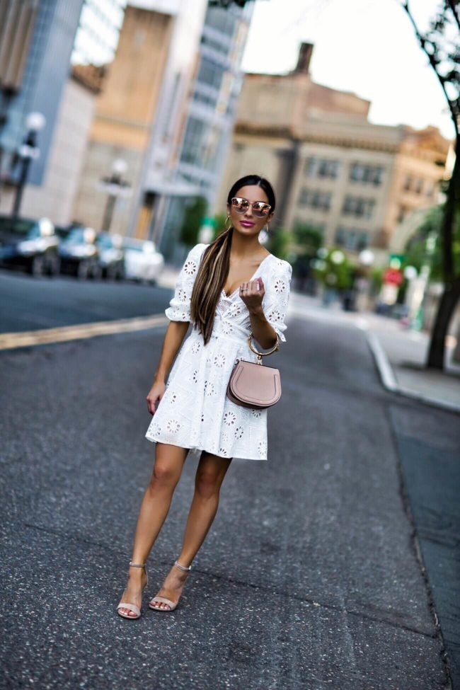fashion blogger mia mia mine wearing a white eyelet dress from revolve and a chloe nile bag