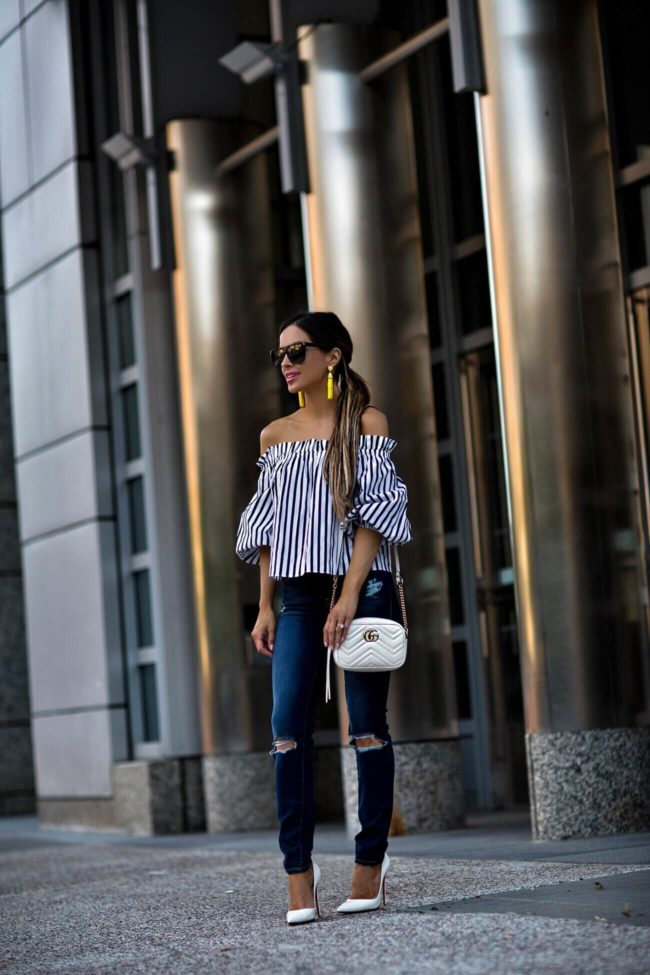 fashion blogger mia mia mine wearing a striped top from revolve and frame denim