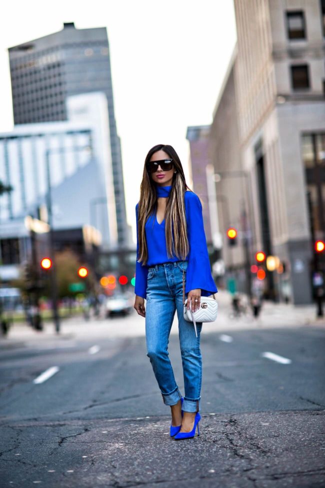 fashion blogger mia mia mine wearing levi's jeans from revolve and jimmy choo blue suede heels