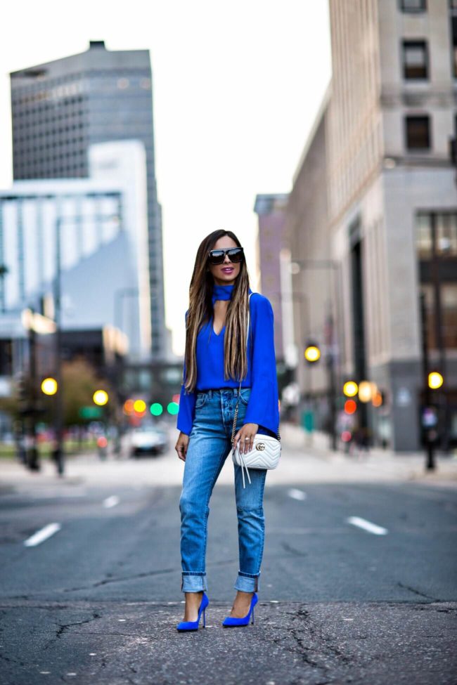 fashion blogger mia mia mine wearing a cutout top from revolve and levis from revolve