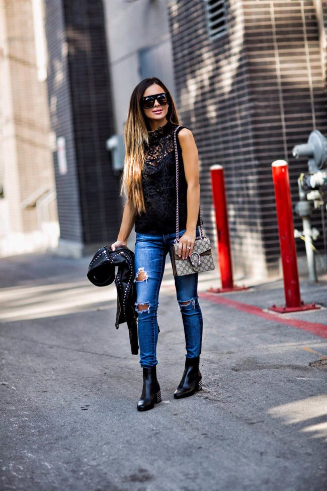 fashion blogger mia mia mine wearing a black lace top from bloomingdale's