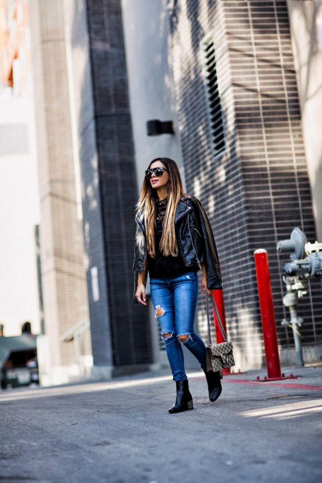 fashion blogger mia mia mine wearing a gucci bag from bloomingdale's and a studded leather jacket by free people