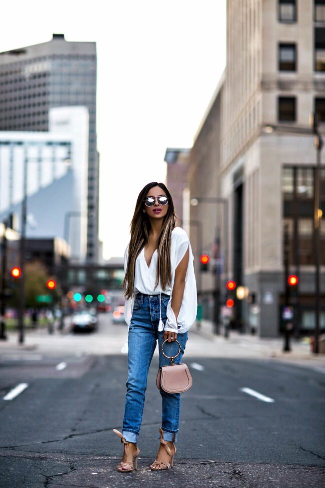 fashion blogger mia mia mine wearing levi's mom jeans and a white bodysuit from revolve