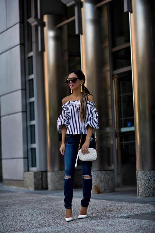 fashion blogger mia mia mine wearing a gucci marmont mini bag and frame denim jeans