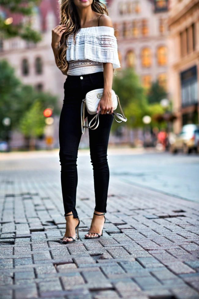 cropped hem black jeans, white off the shoulder top, ankle heels