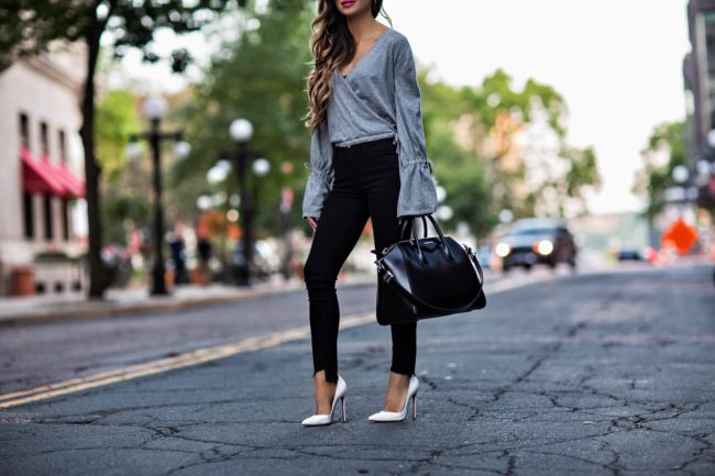 Black skinny jeans, gray wrap top, large black Givenchy tote, Christian Louboutins white heels