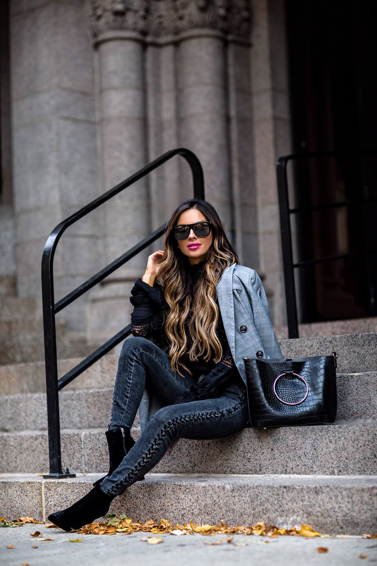 fashion blogger mia mia mine wearing a gray plaid blazer and black leather bag from bloomingdale's