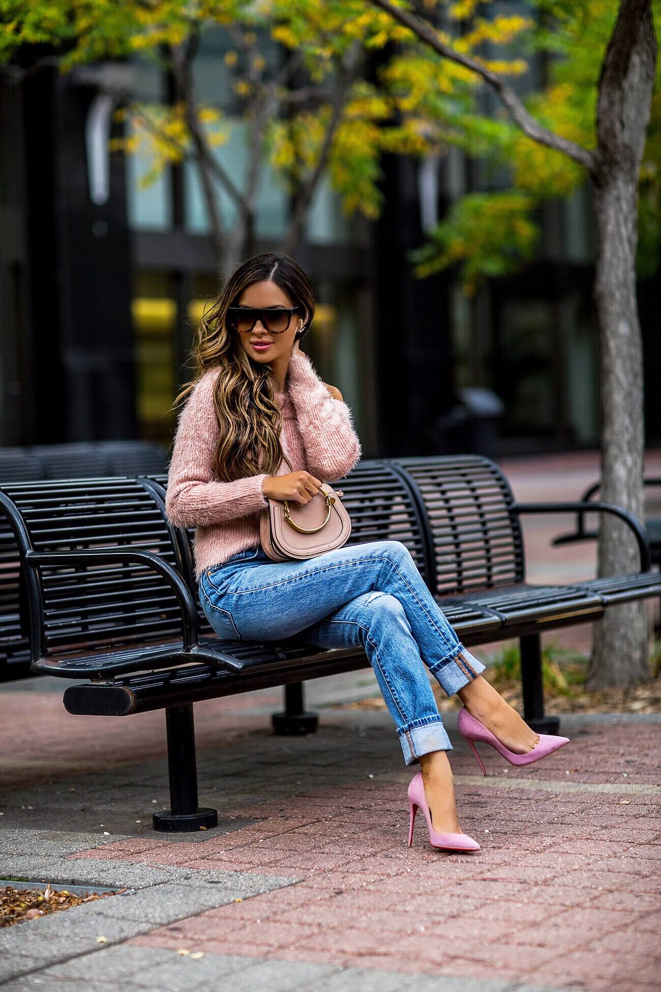 fashion blogger mia mia mine wearing a pink fuzzy sweater and a chloe nile bag