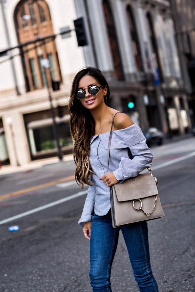 fashion blogger mia mia mine wearing a striped off-the-shoulder lovers + friends top from revolve