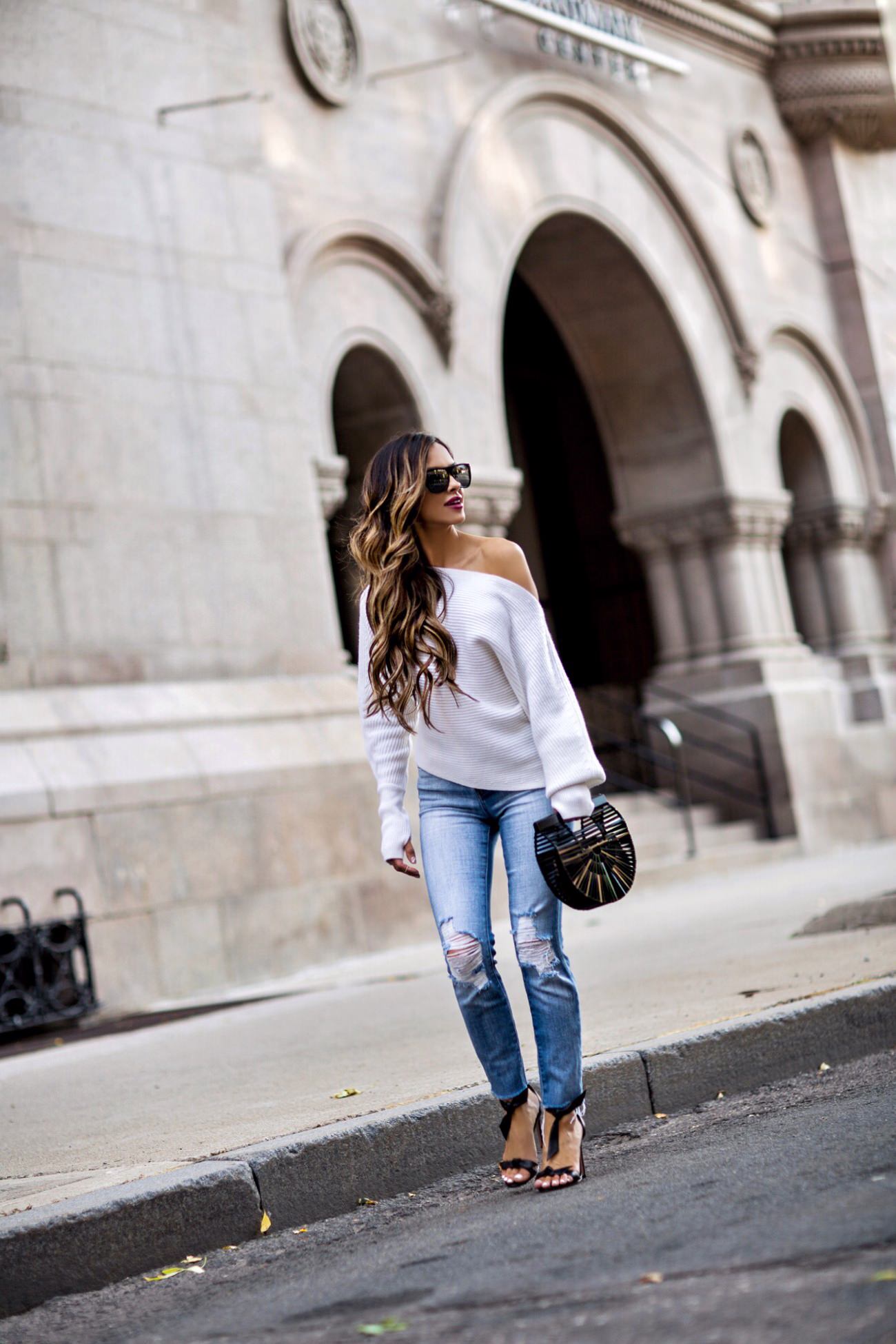 fashion blogger mia mia mine wearing a white sweater from intermix and l'agence jeans