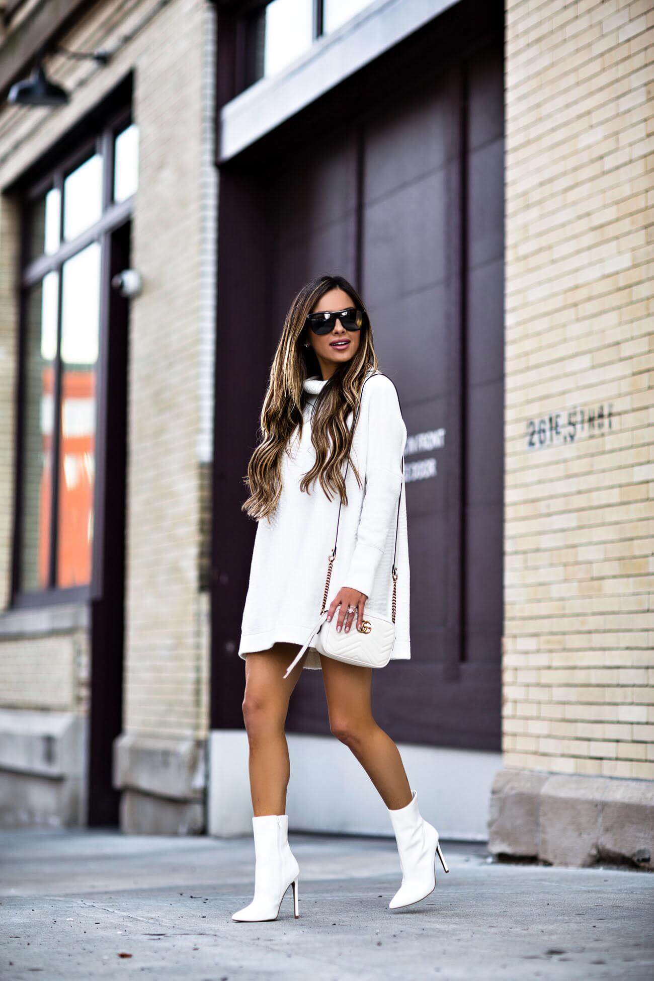 fashion blogger mia mia mine wearing a white sweater dress from macy's and steve madden white booties