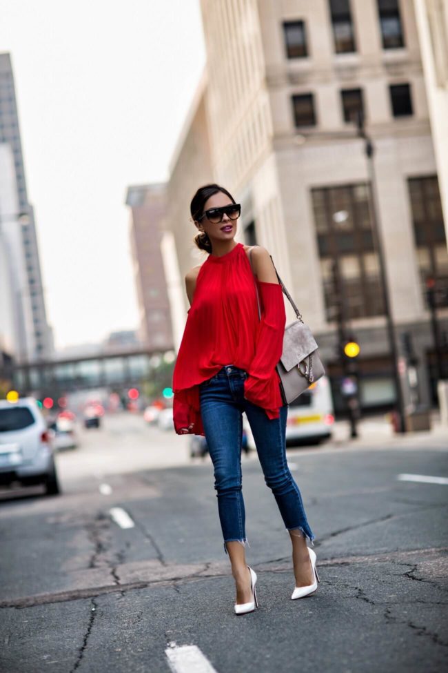 Minnesota fashion blogger wearing Style Mafia red op with pleats, Rag & Bone Step Hem jeans, Jules Smith Hoop Earrings, Chloe Faye bag, Celine sunglasses