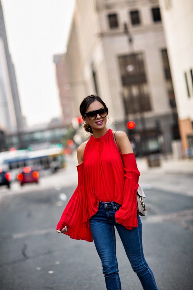 Maria Vizuete of Mia Mia Mine wearing Style Mafia red op with pleats, Rag & Bone Step Hem jeans, Jules Smith Hoop Earrings, Chloe Faye bag, Celine sunglasses
