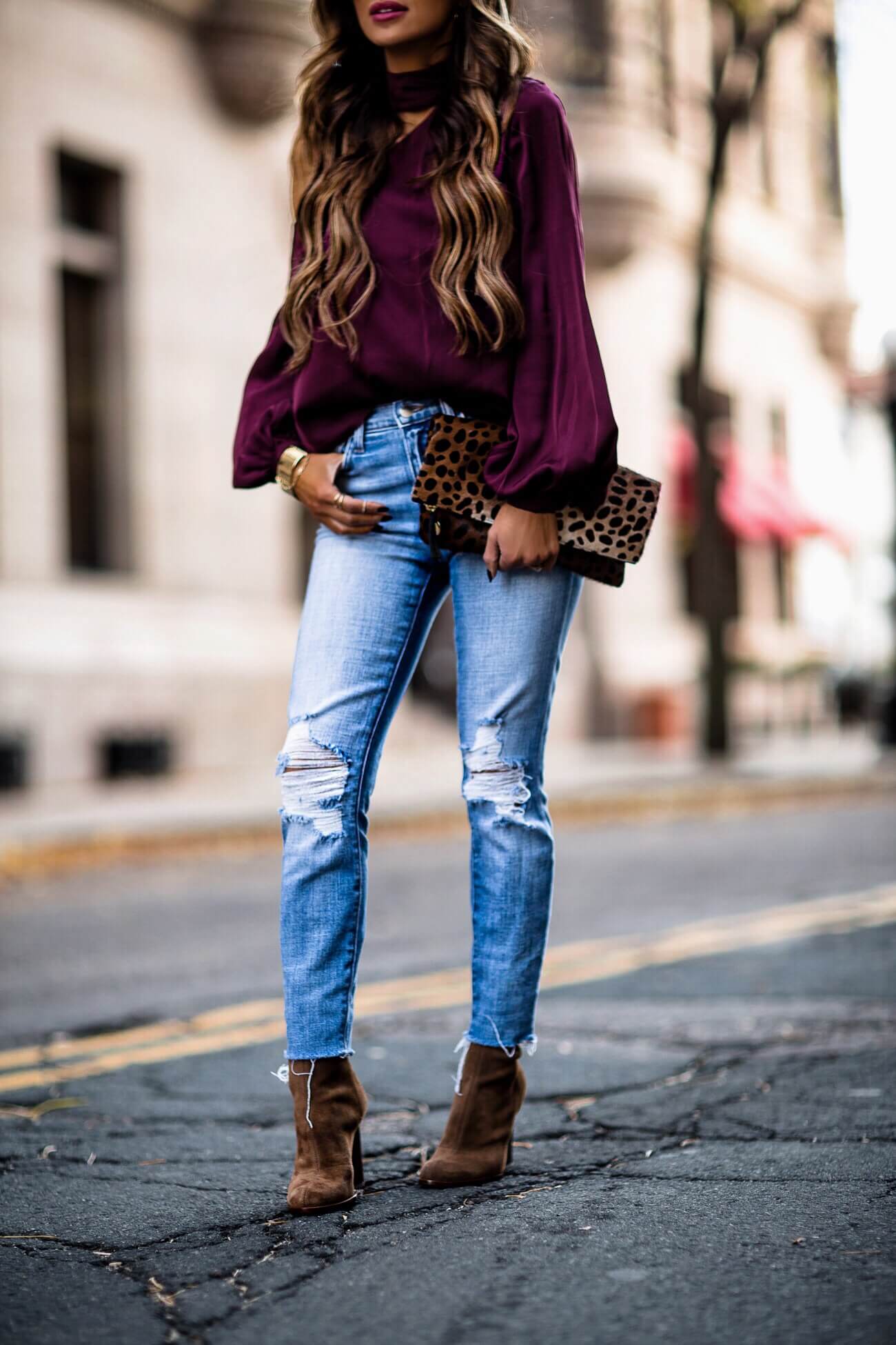 fashion blogger mia mia mine wearing a purple top from intermix and alexander wang booties