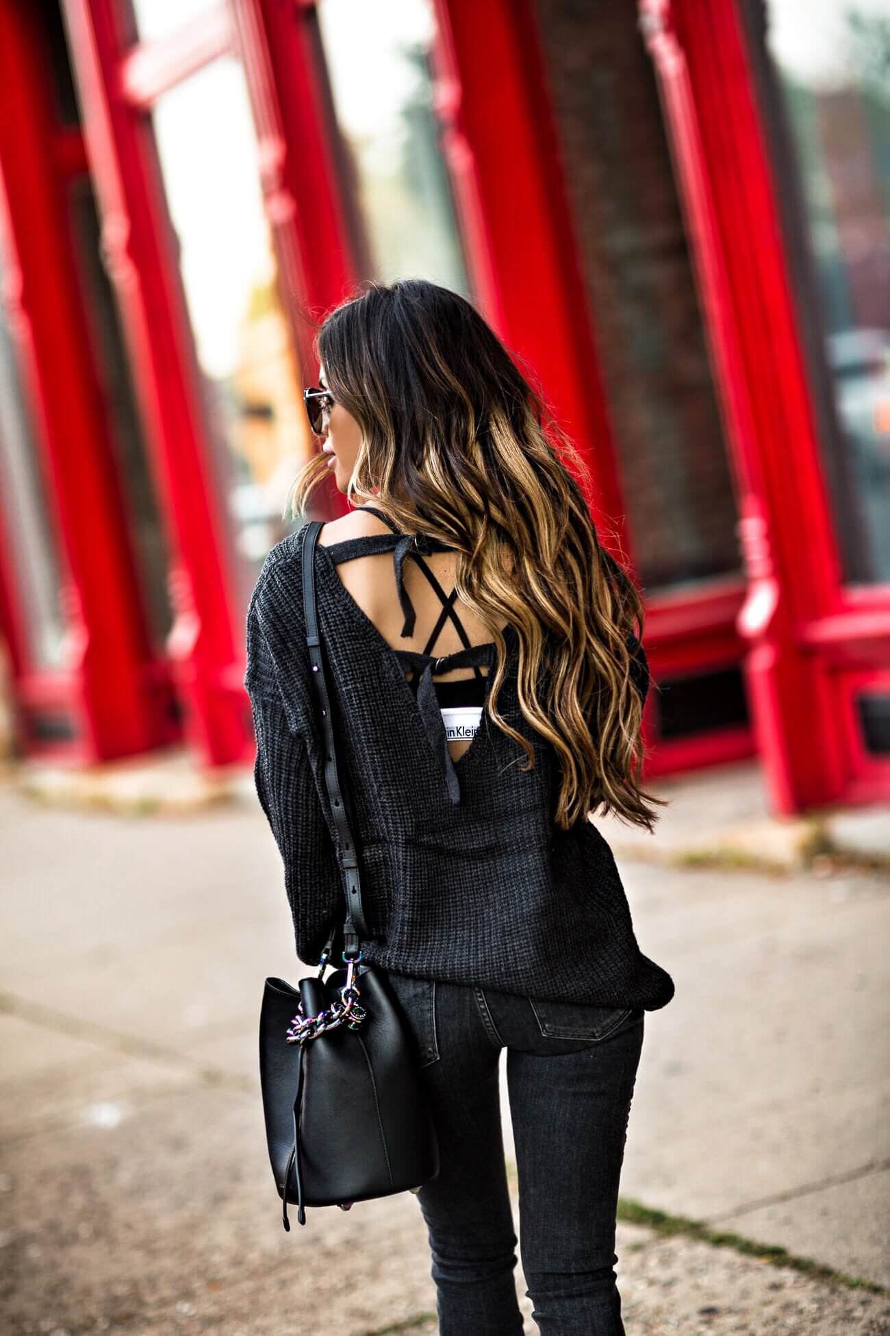 fashion blogger mia mia mine wearing a black backless sweater and a kendall + kylie bucket bag from bloomingdale's