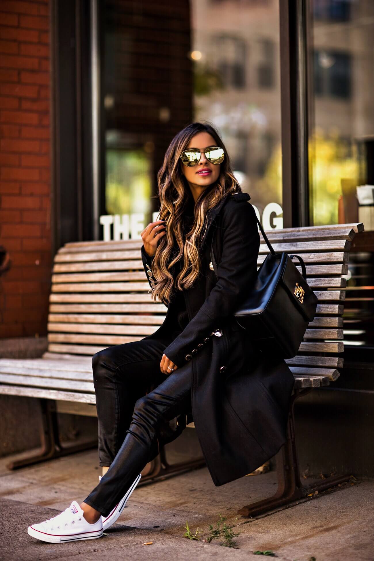 fashion blogger mia mia mine wearing a black coat from macy's and converse sneakers