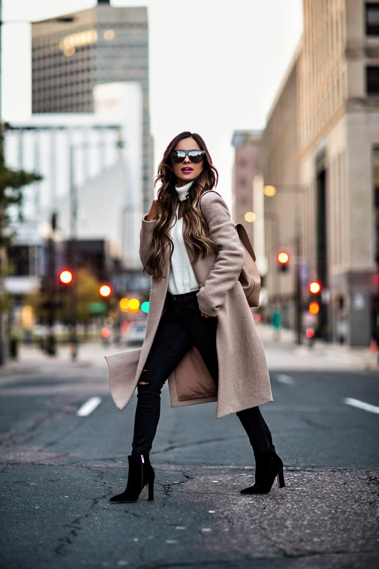 fashion blogger mia mia mine wearing a camel coat and white cutout sweater from bloomingdale's